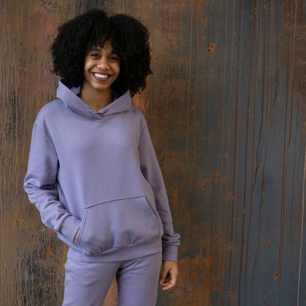 Portrait of a content and smiling woman in comfortable sportswear.